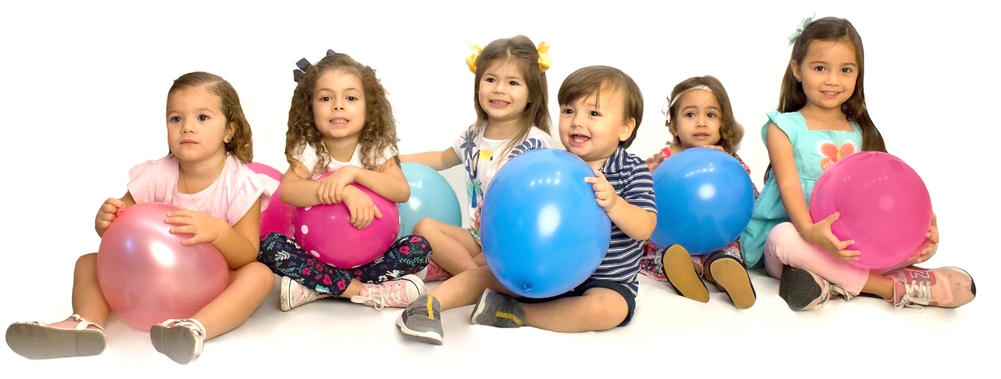 Little kids holding balloons